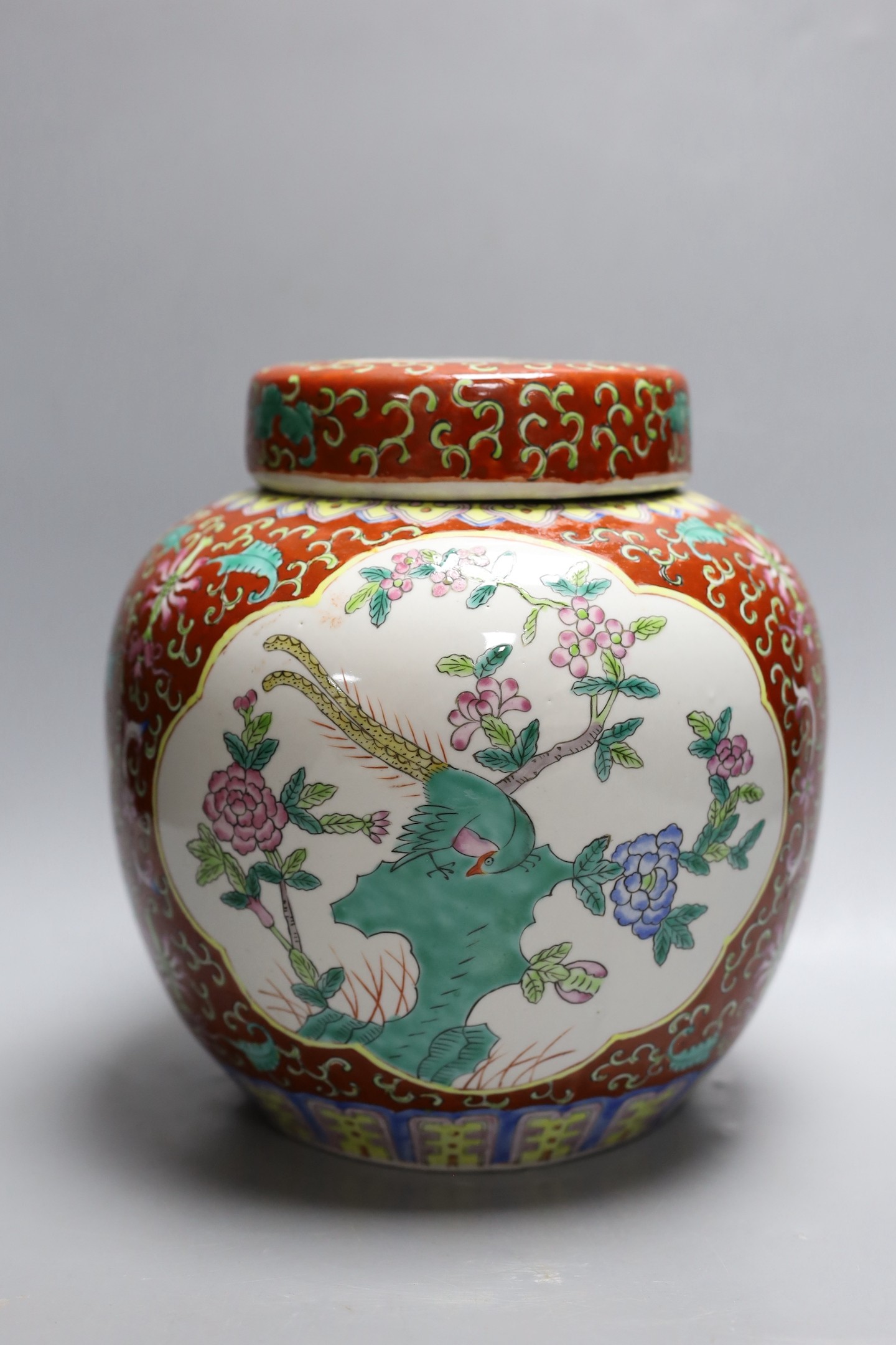 A Chinese coral ground jar and cover, 23cm